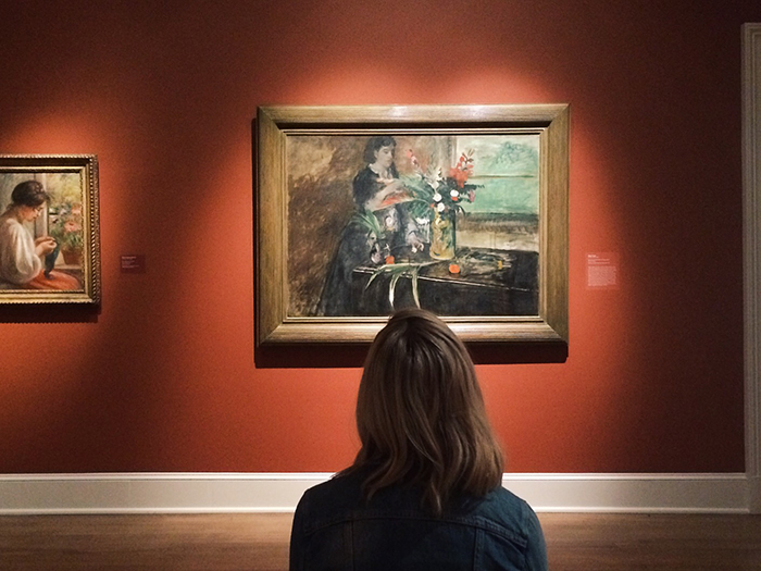 A woman looking at a painting