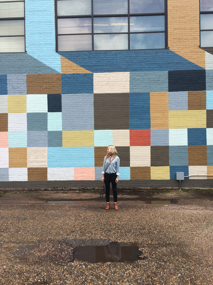 Amy Hood standing in front of a mural in baton rouge