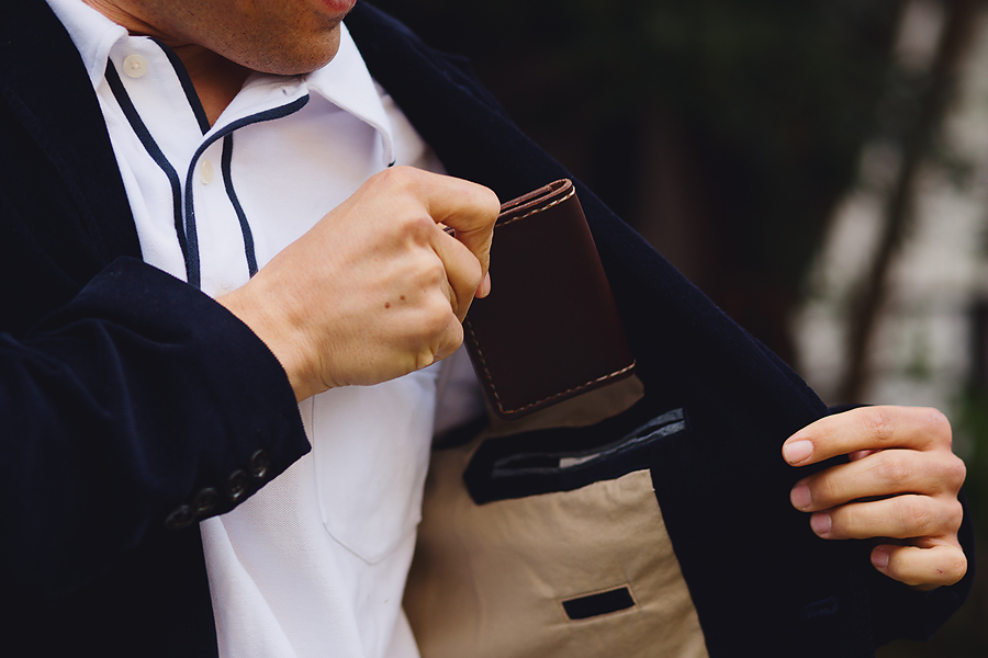 Man placing Headlands Handmade wallet in his pocket