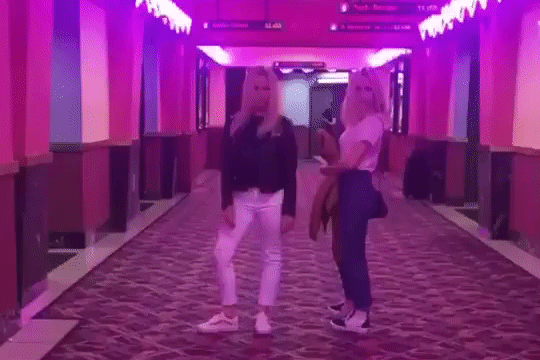 Jen and Amy Hood boomerang standing in the halls of the movie theather