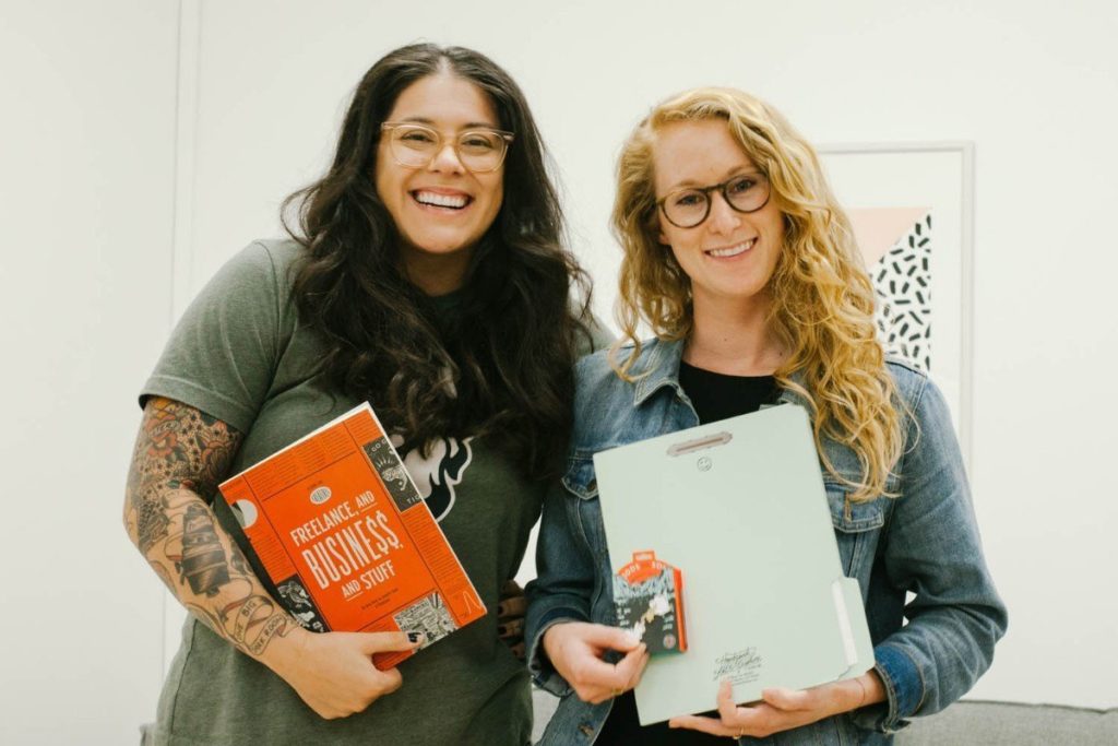 Two girls holding books and workbooks at the San Fransisco FABAS workshop