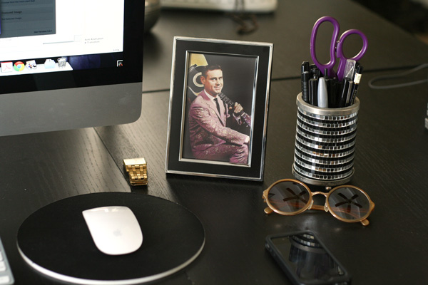a framed photo of George Jones on a computer desk