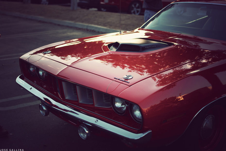 photograph of the front of a candy apple red Plymouth Barracuda