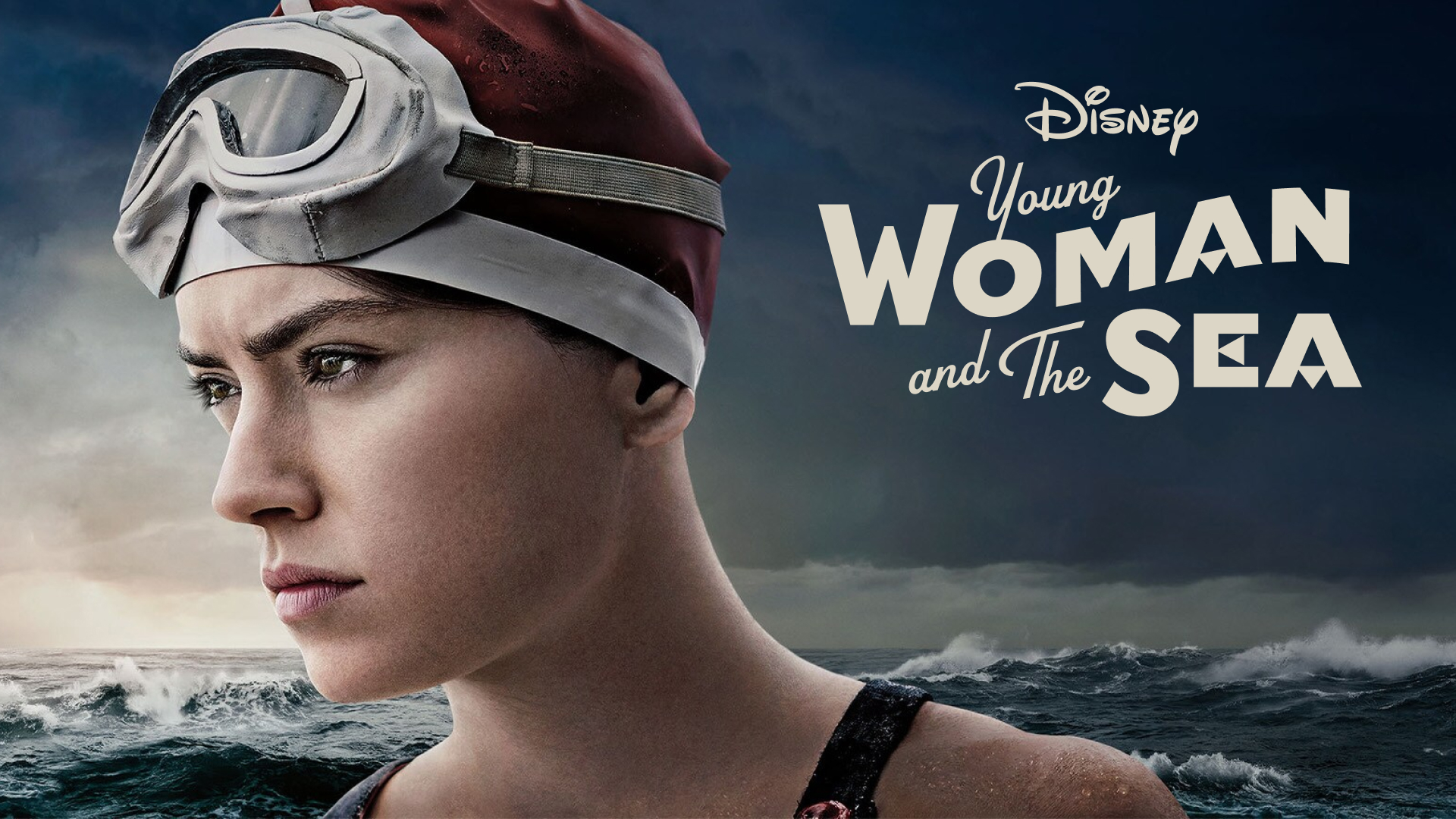 Disney's Young Woman and the Sea movie still of the woman looking out at the sea with a logo on top