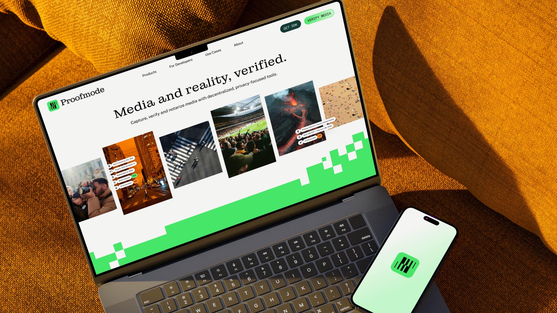 Proofmode website showing on a laptop with an iphone previewing the logo